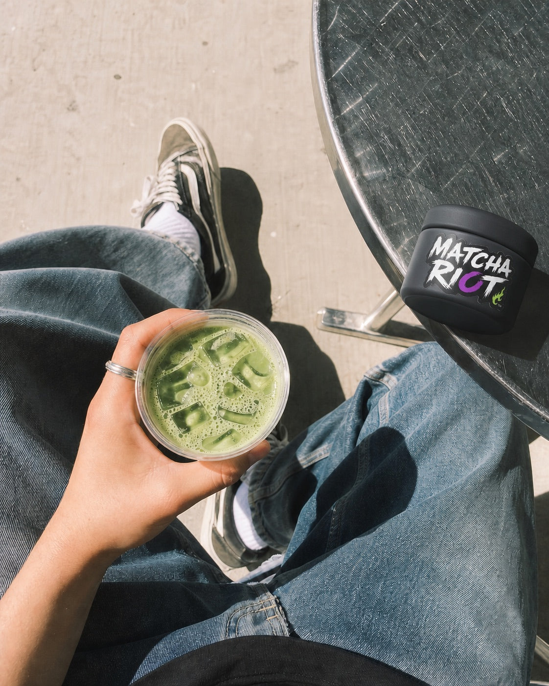 Matcha Riot beside an iced matcha in a creative everyday setting